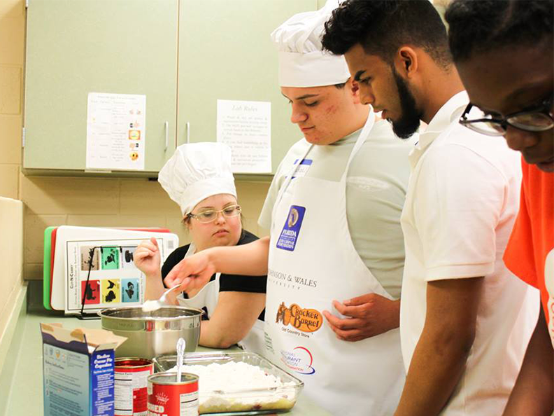 Students learn the skill of making a dump cake.