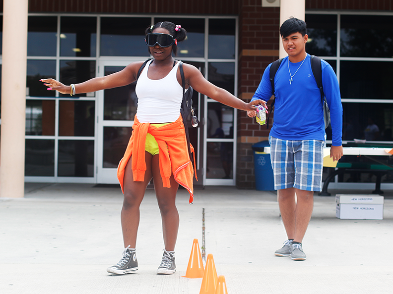 Students participate in a prom week event, using DUI goggles, to experience the feeling of being drunk and performing cognitive actions. This activity is part of the schools effort to keep students safe at prom by preventing student drinking.