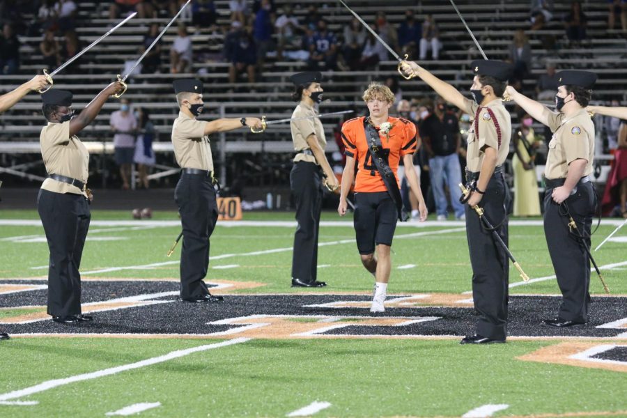 ROTC+members+form+an+entrance+for+senior+Bryson+Dunsworth+at+homecoming+game.+