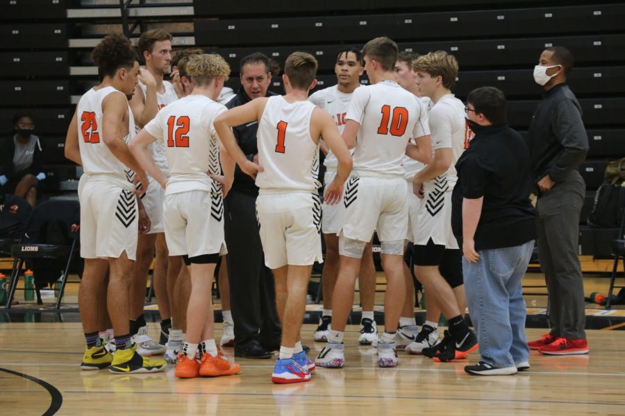 Coach Jason Vallery talks to his team in the huddle during a timeout in a hometown showdown
against rivals Hagerty High School on Jan. 8.
