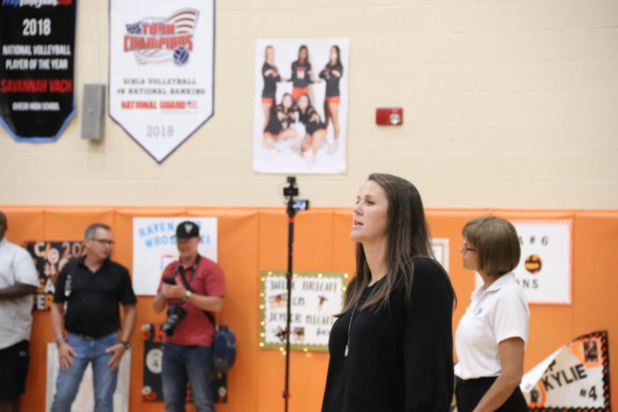 Jennifer Darty watches a varsity girls volleyball game.