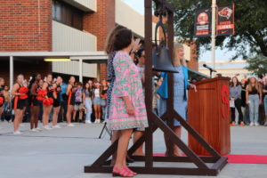 School board members ring the old bell to celebrate Oviedo High Schools 100-year event.