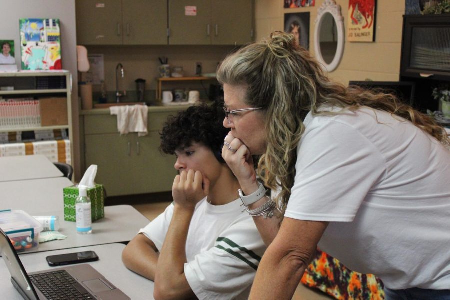 Kimberly Finnegan assists a student in revising their college essay.