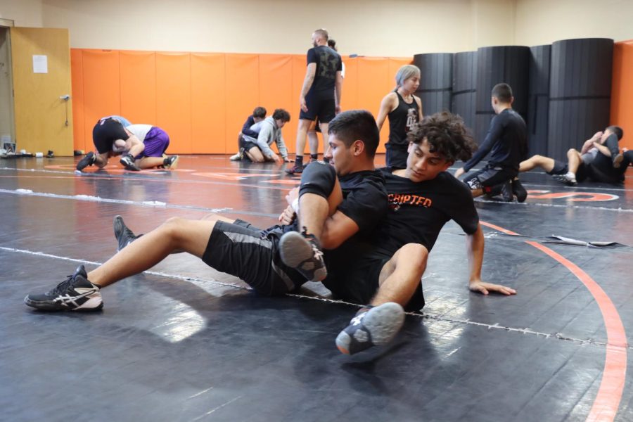 Eric Esquivel practices wrestling with his teammate to prepare for upcoming matches.