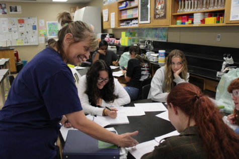 Teacher Kathy Savage helps her students learn the biotech material.