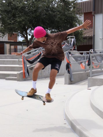 Sophomore Aidan Carvajal flies through the air as he preforms a trick on his skateboard.