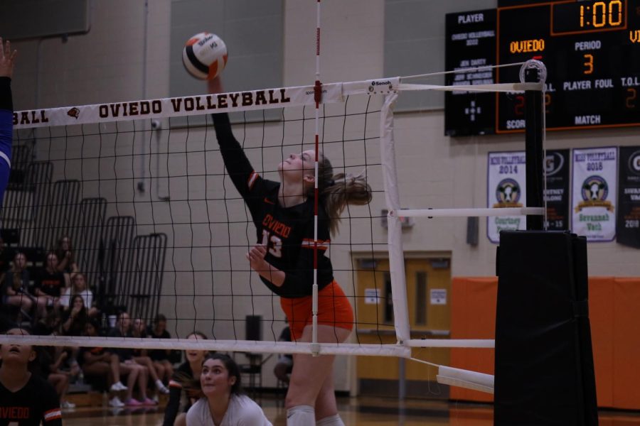 Sophomore Anna Cathcart hits the ball over the net socring a point for the lady lions.