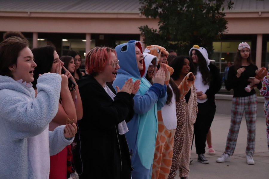 Dressed up and cozy, students cheer for the best of the pj outfits for the night at sea theme.