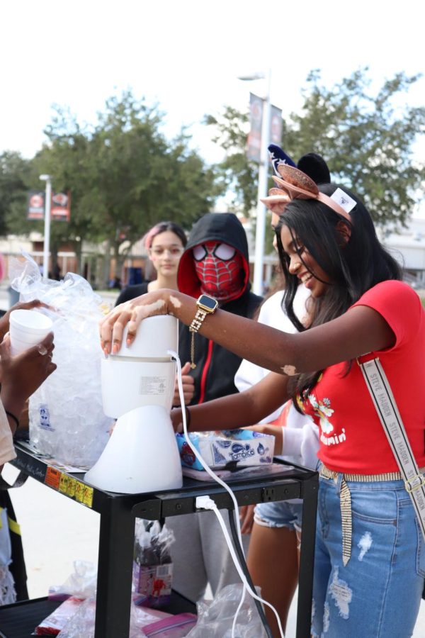 The Black Student Union makes snow-cones for fellow students during the lunch carnival.