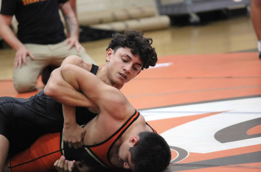 Andres Millan from the black team throws an arm bar on Eric Esquivel from the orange team to get a pin.