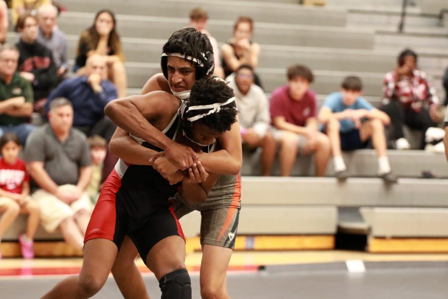 Wrestler Eric Esquivel begins a take down from the wrestling match on March 20th. 