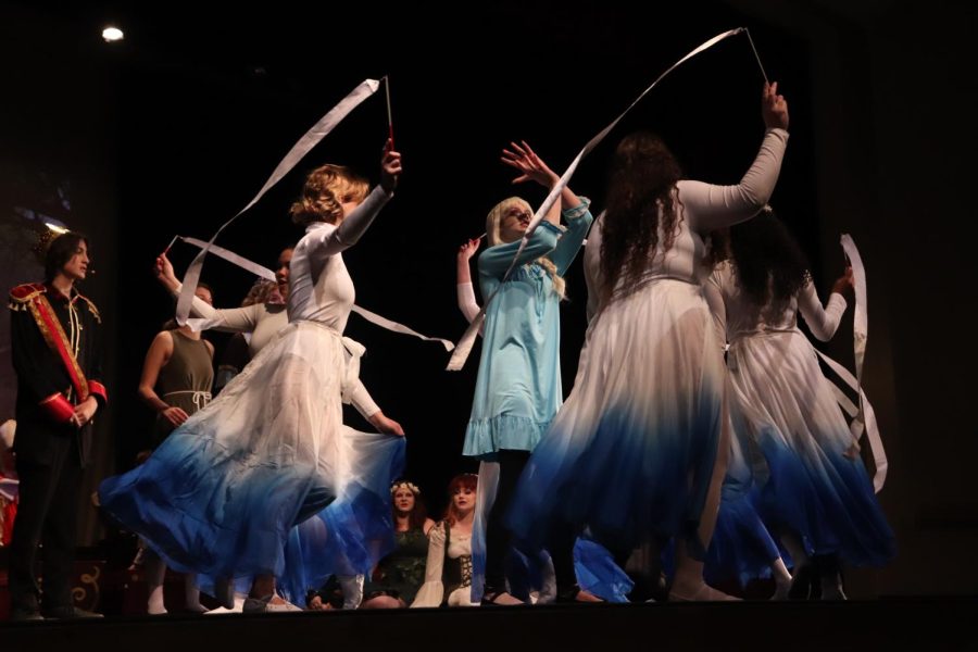 Taking a good spin on magic, dancers spin around Elsa as she uses her powers.