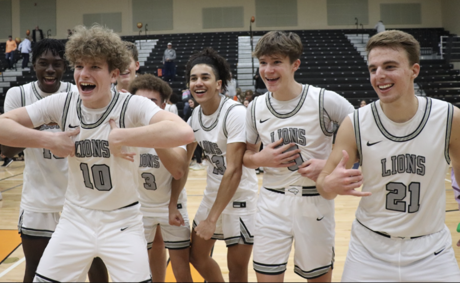 Jackson Latour (left) and Trenten Wollmer (center-right) celebrate with the squad after a big win on senior night.
