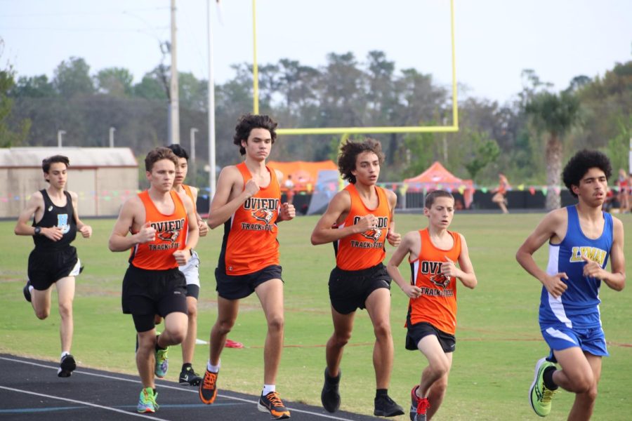 The track team bolts down the line, eyes locked on the finish.