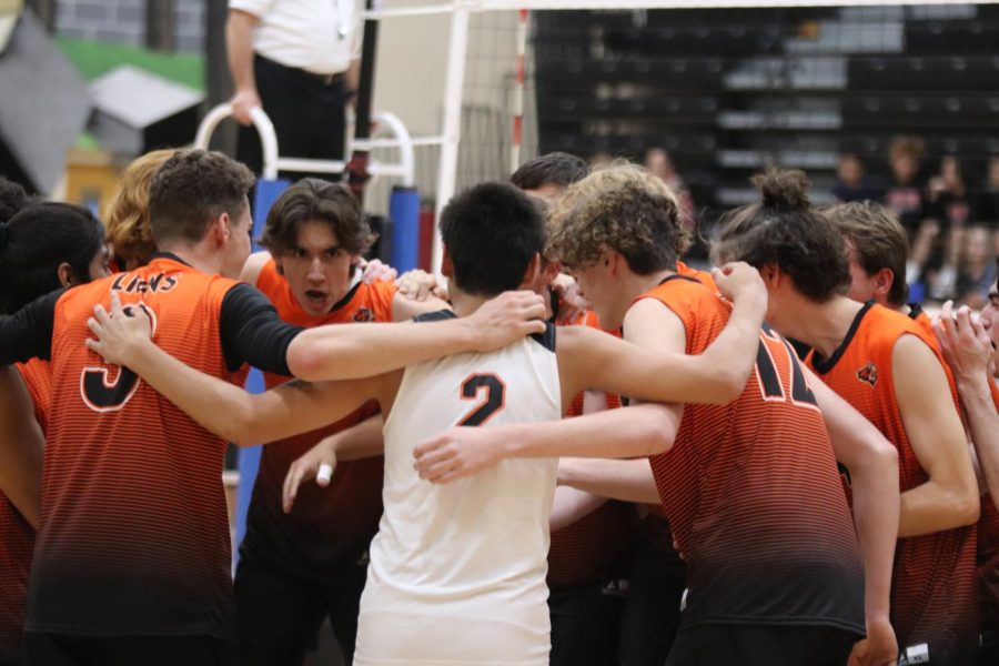 The boys volleyball team huddles up, celebrating the end of a successful season together. Photo by Diego Lara.