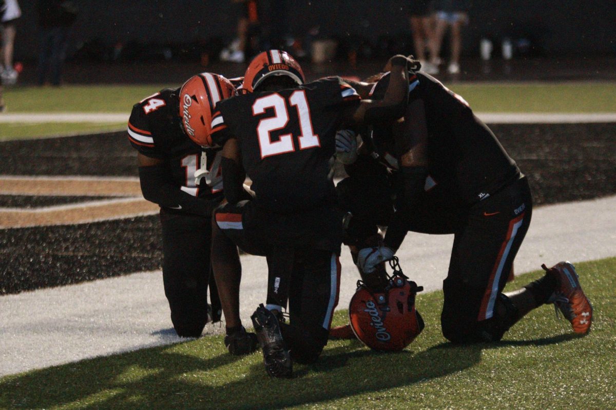 Junior, Jaylen Lewis, takes a knee before the opening kick off against Deltona.
