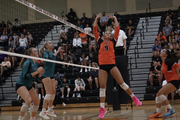 Junior setter, Olivia Klimis, sets the ball to the outside in their season opener against Olympia. Oviedo went on to beat Olympia in 4 sets. Klimis had 24 assists and 7 kills.