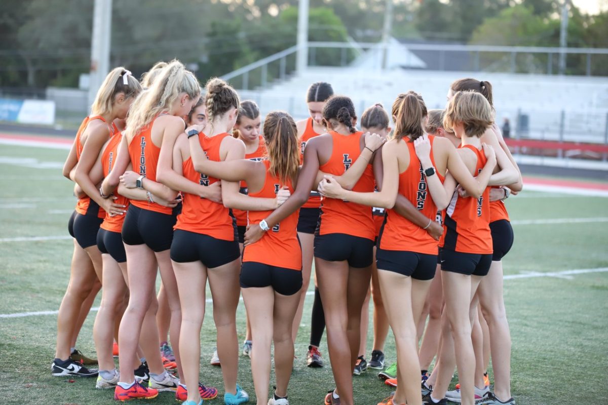 Oviedo’s cross country team huddles in preparation for the first of their champion season. 