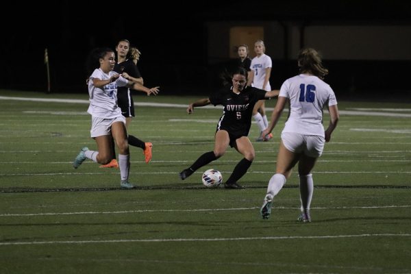 Sophomore, Mia Wetzel,  moves to pass the ball down field during the lions 5-0 win against Apopka Highschool. 