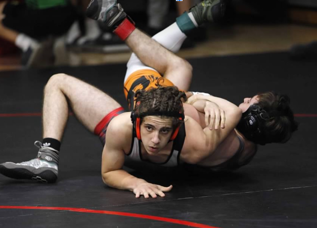 Junior, Caden Martz hits a cross face turk in order to try to pin his opponent.