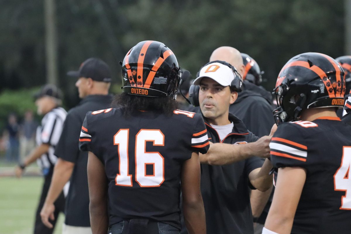 Coach Odierno gives play call to senior starting quarterback Jerome Curry. 