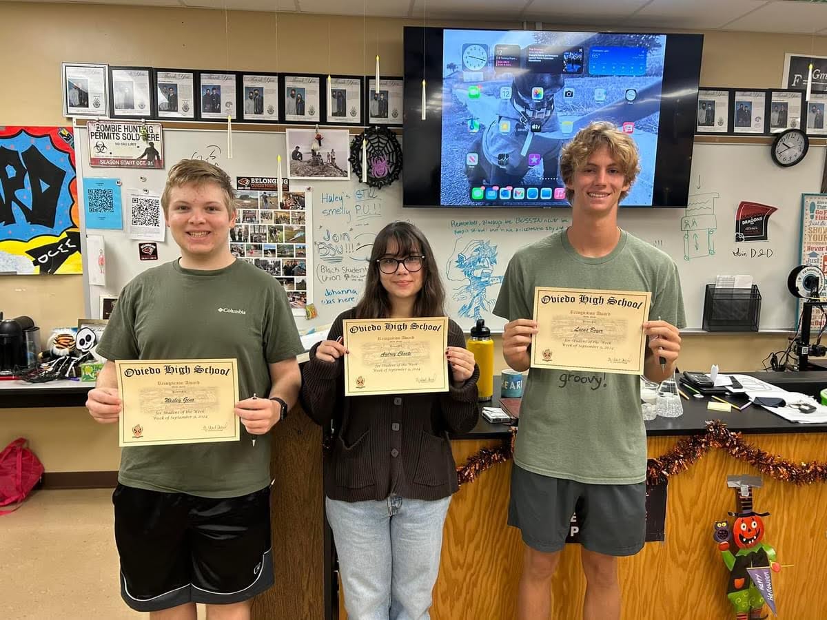 Three of the semifinalists stand side-by-side to display their certificates of recognition.