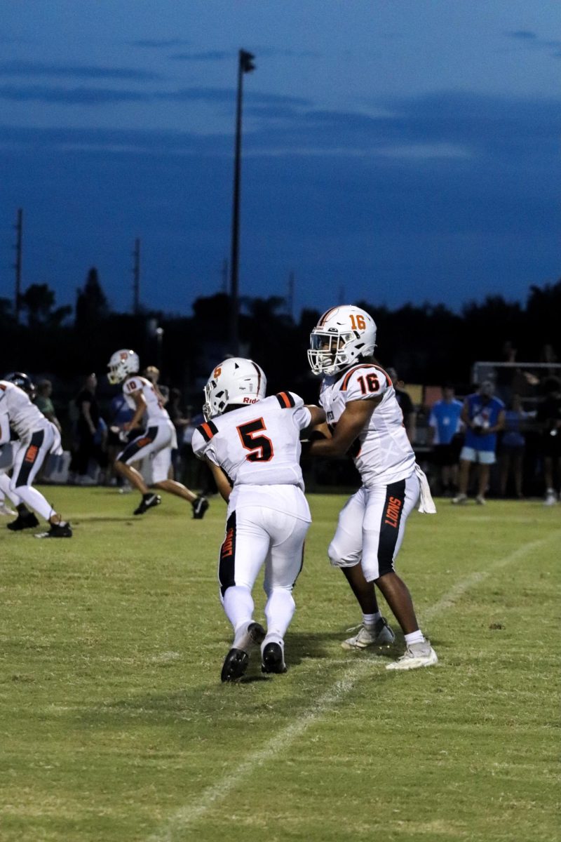 Senior running back Chance Nixon receives the ball from Curry, adding to his 107 rushing yards for the game. 