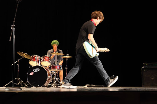 On Tuesday, September 24th, the Finlawgs won the Judge’s Choice Award for their band's performance at the annual Homecoming Talent Show. Above, seniors Tristan Amstadt sings while Lucas Boyer plays drums to the song “Basket Case” by Green Day. Outside of the frame, freshman Elliot Boyer plays the bass guitar and senior Owen Sommerfeldt plays the electric guitar. 