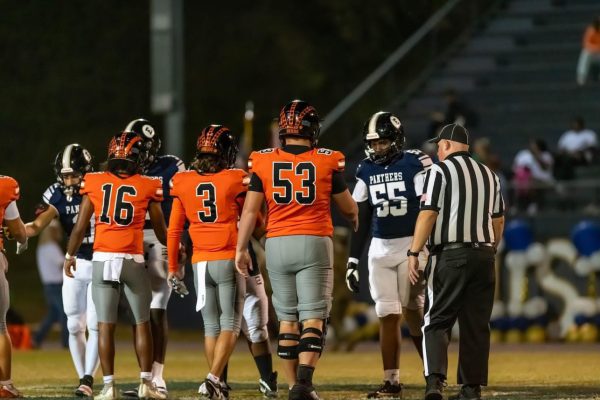 Oviedo's captains, Brady Manning, Jerome Curry, and Nathan Tveit (left to right) line up for pre-grame coin flip against Eustis.  