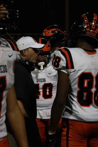 Oviedo's offensive line talks to Coach O during game. 