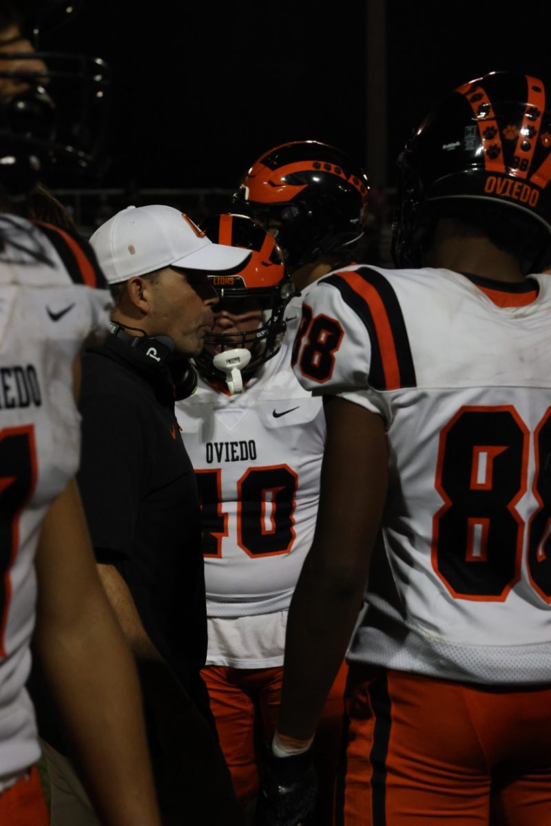 Oviedo's offensive line talks to Coach O during game. 