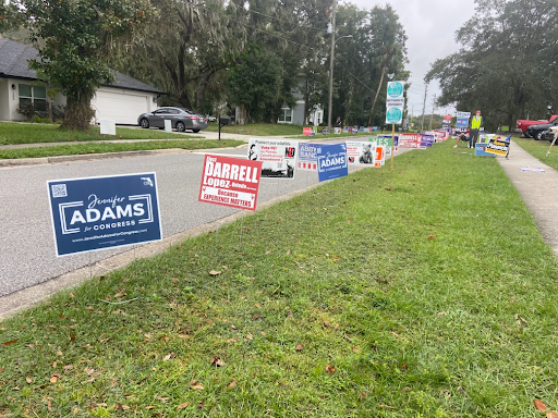 Signs line the walkway of one of the places Oviedians can cast their votes, the Seminole County Public Library.