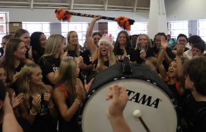 Taylor White, senior, hypes up the students body along with fellow cheerleaders at a Pep Rally.