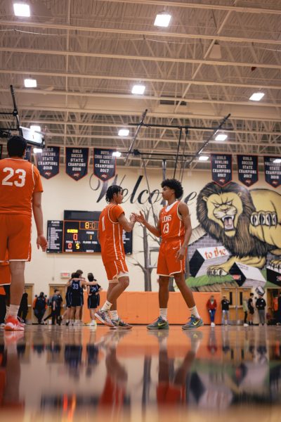 Aidan Demeglio daps up Terrell James while preparing for the game. 