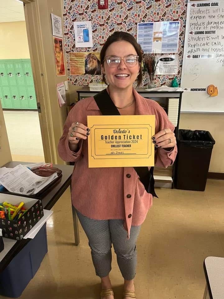 Kristen Jones holding up her Golden Ticket for “Chillest Teacher” during the 2024 Teacher Appreciation superlative awards.
