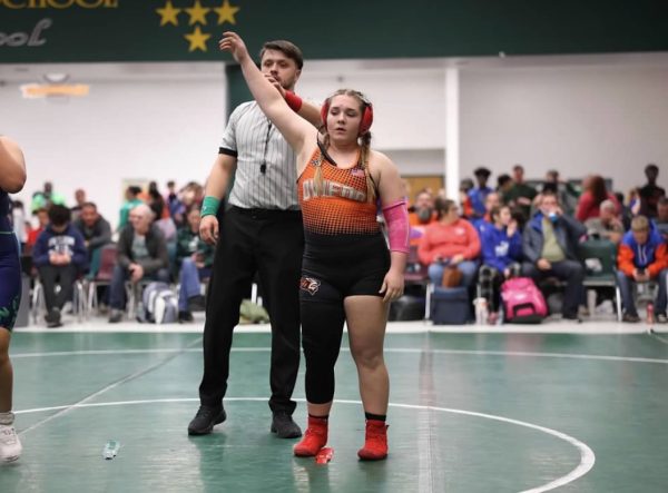 Sophomore Haylee Richards raises her hand after earning a tough fought victory.