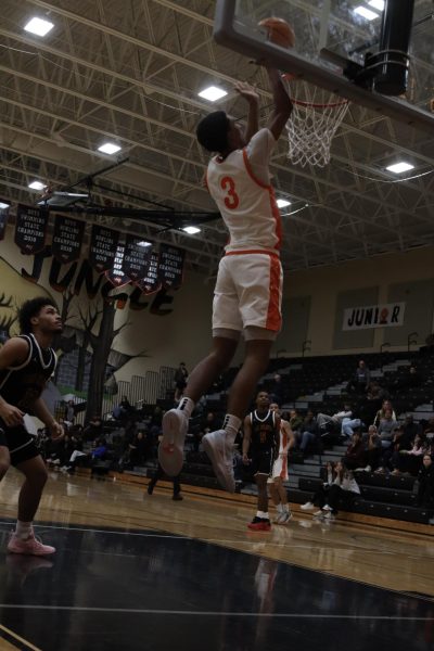 Cam Bryant dunks basketball2 against St. Cloud. 