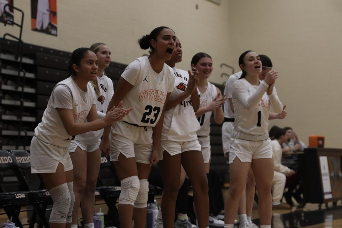 Lion's bench  cheers on teammates against Lake Mary. 