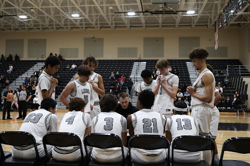 Oviedo’s JV squad huddled around head coach Tate Morse for the next play call.
