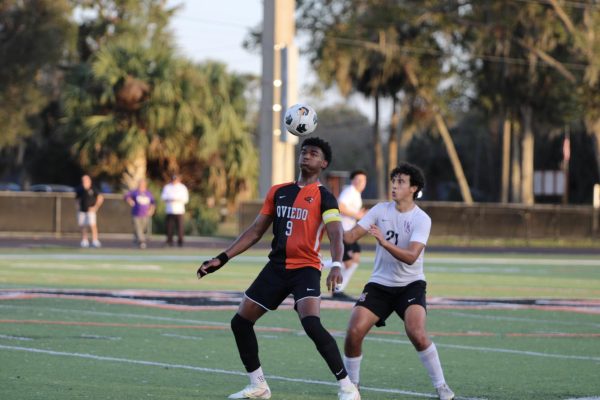 Senior striker Ellison Ruffin contesting a header against his Winter Springs opponent.