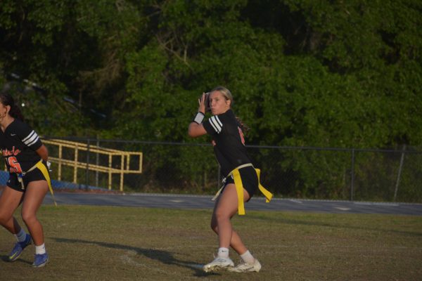 Senior Ansley Devos prepares to throw the football to a receiver. Devos runs the play to get the first down.