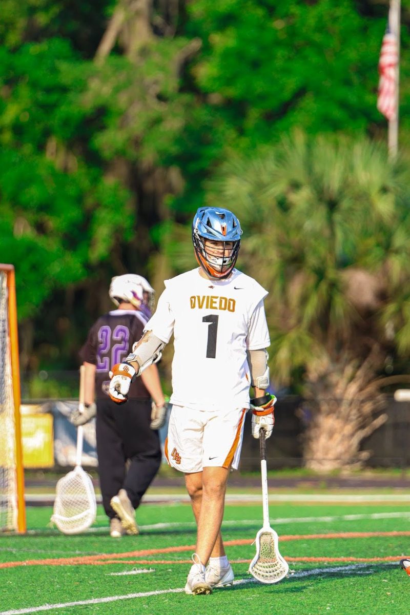 Ridder walks through the field before a lacrosse game, preparing to lead their team. Though being lacrosse captain is one of the many responsibilities they have to navigate, they handle it with ease. “There’s the saying that hard work beats talent when talent doesn’t work hard. Trey is talent that works hard,” Mr. Woodruff said. 