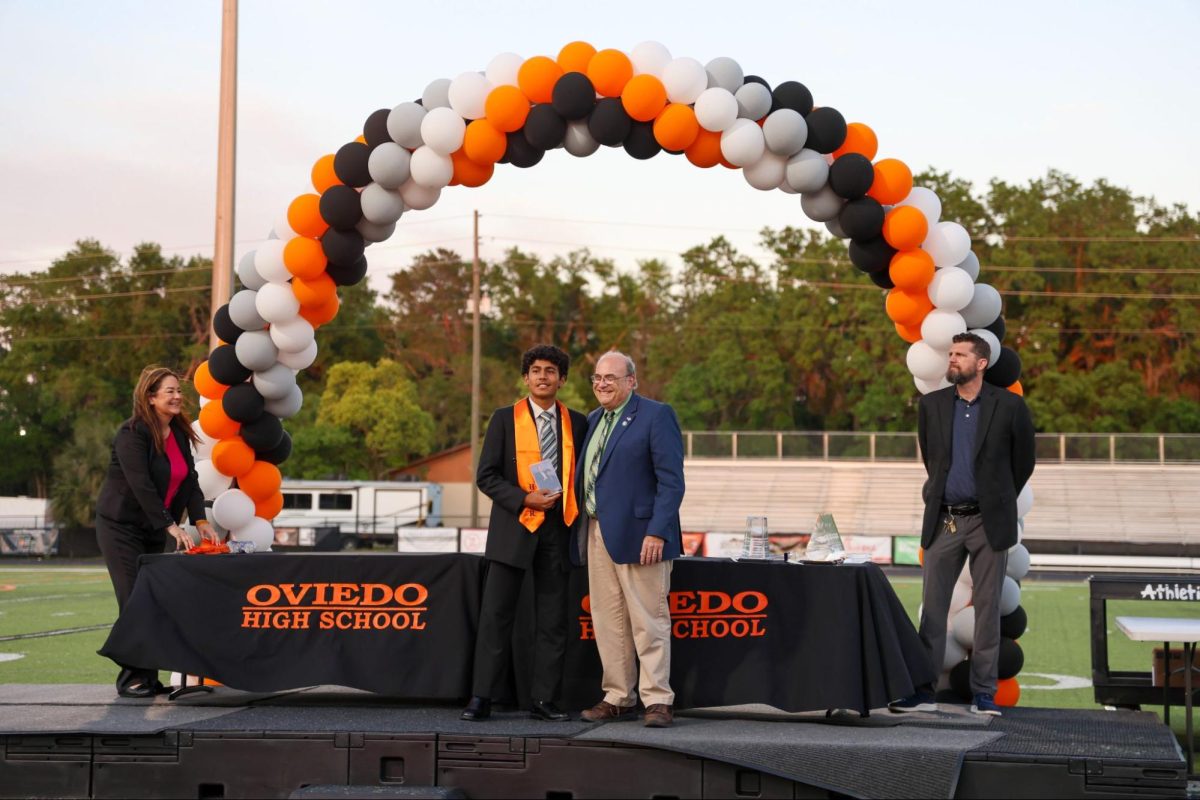 Om Telang at the honor-grad ceremony next to physics teacher, Art Woodruff. Telang found significant academic importance in Woodruff’s class, and found it most fitting to stand upon the stage with their most influential teacher. This will be one of the heights of Om Telang’s senior year, and to spend it with such an admired mentor made it so much more special.