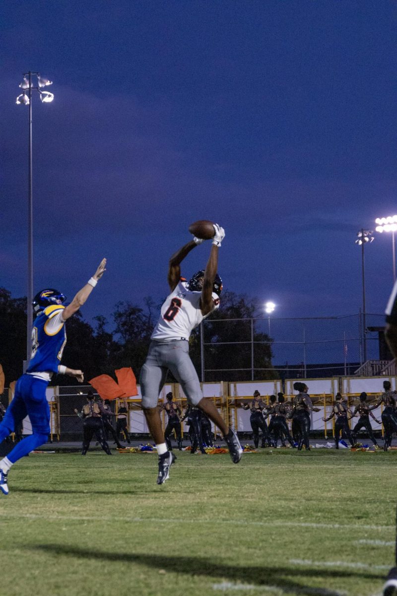 Senior DaShon Febres jumps to catch a pass from quarterback Sebastion Galeano. 