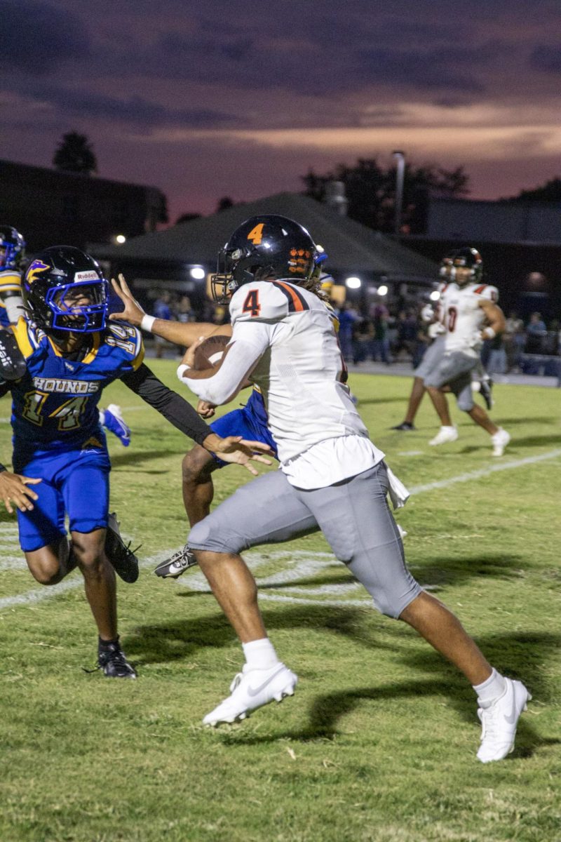 Senior Johnnie Cobbs caries a handoff up the sideline. 