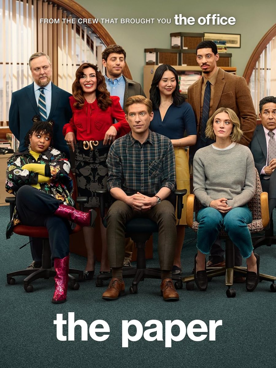 The promotional poster for the show depicts the employees of the fictional newspaper the Toledo Truth Teller sitting in the newsroom. Characters include (clockwise from top left) Ken, Esmerelda, Adam, Nicole, Detrick, Oscar, Mare, Ned, and Adelola. Images courtesy of Deedle-Dee Productions/Banijay Americas/Universal Television
