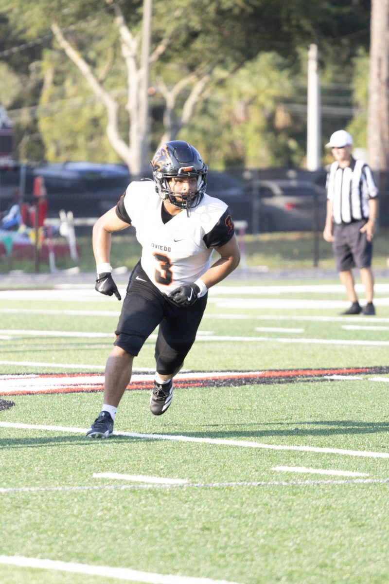 Aiden Bermudez, sophomore tight end, runs down the field during a junior varsity football game against Lake Mary on August 28.