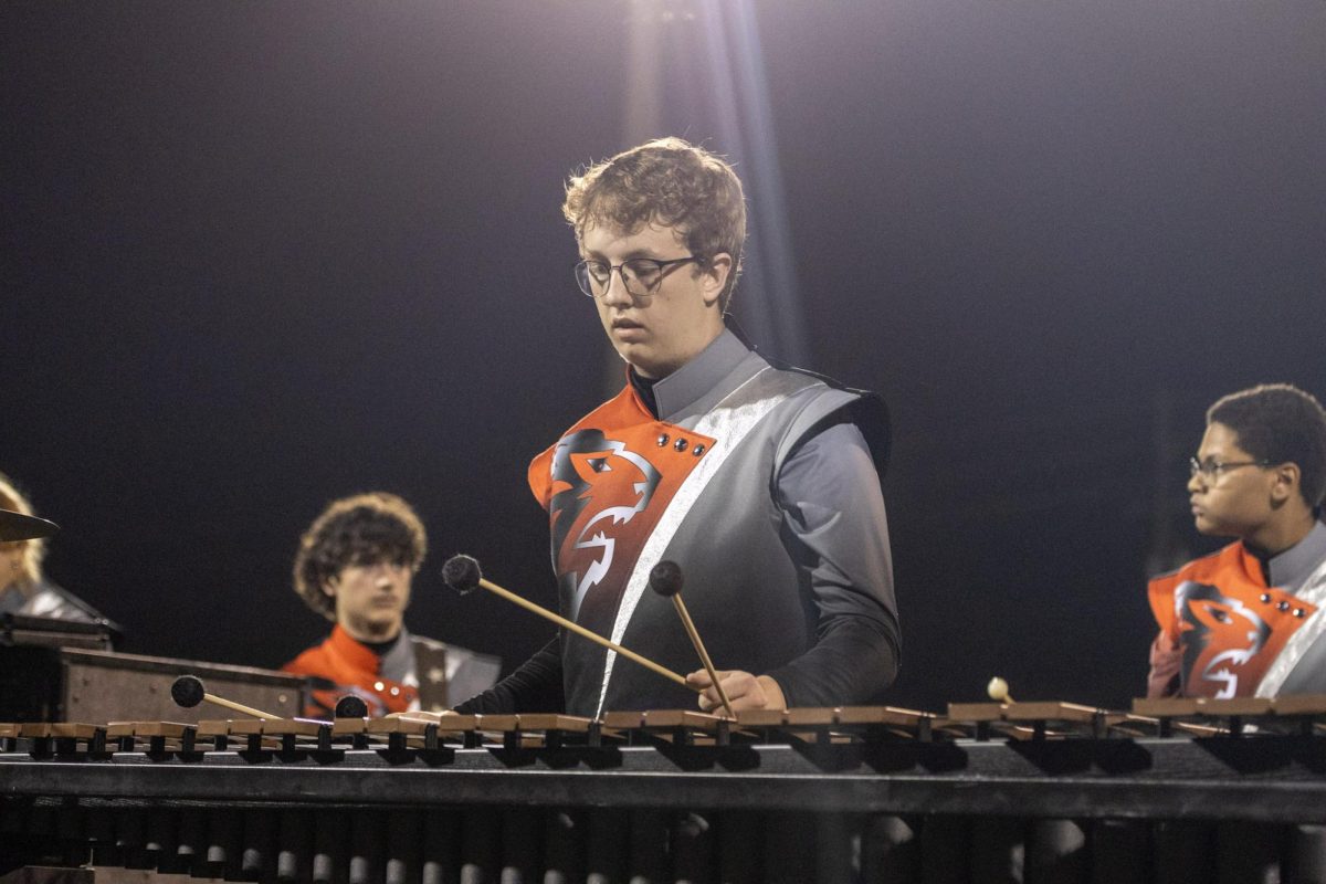 Marimba player Maxwell Glenn (11) performs the opener of Colony 1, "Ethereal," during the halftime show in the game against Hagerty on 10/3/25. 
Glenn serves as a section leader of the Oviedo Marching Lions Front Ensemble and this is his third year in the section.
