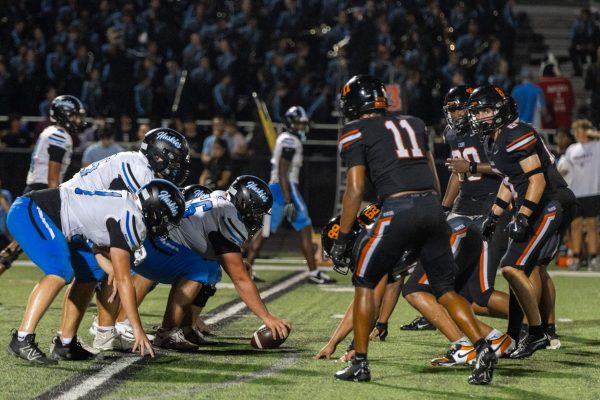 The Lions and Huskies are face to face, awaiting the snap during the rival game. 