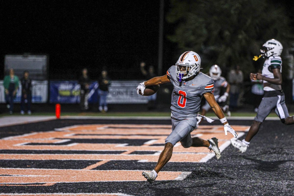 Senior Emiliano Galarza runs the ball into the end zone, scoring a crucial touchdown in Oviedo's Homecoming game versus Evans High School.